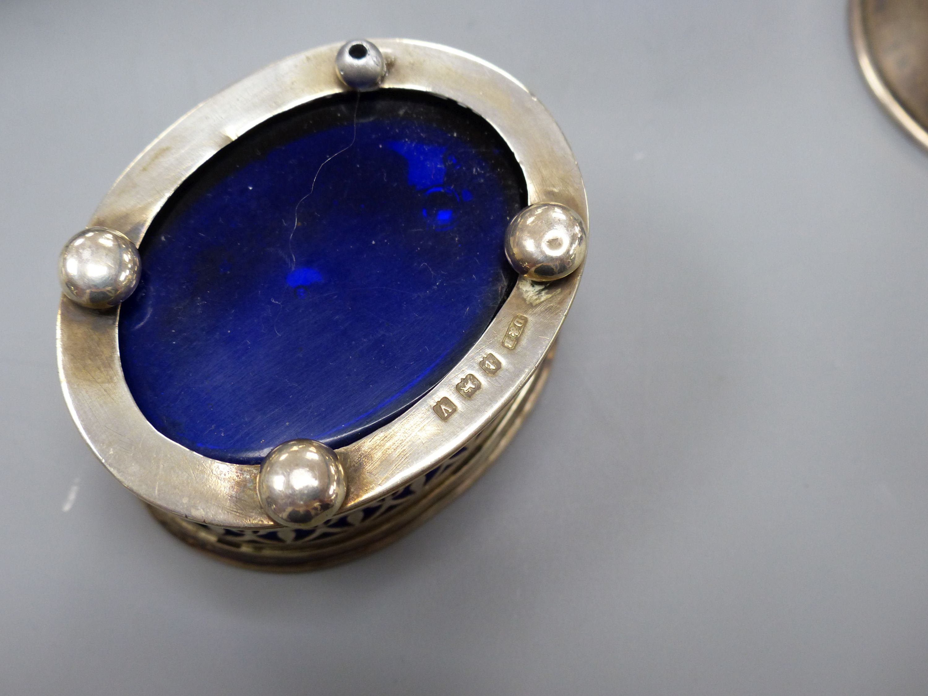 A pair of Edwardian pierced silver quatrefoil shaped salts with blue glass liners, London, 190987mm and three other smaller silver salts.